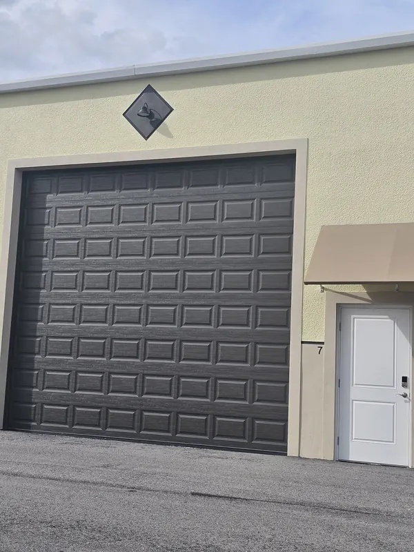Overhead door and entry door on a garage condo unit